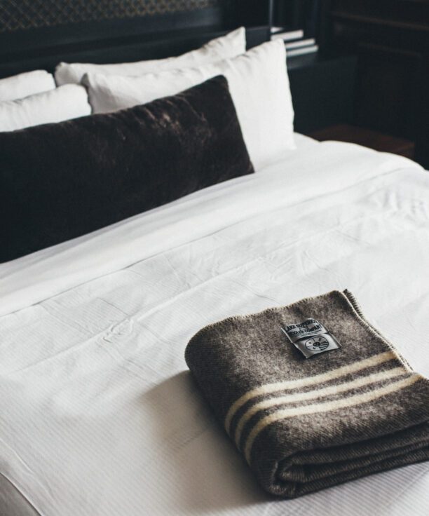 Folded throw blanket on a bed at our historic downtown Detroit hotel