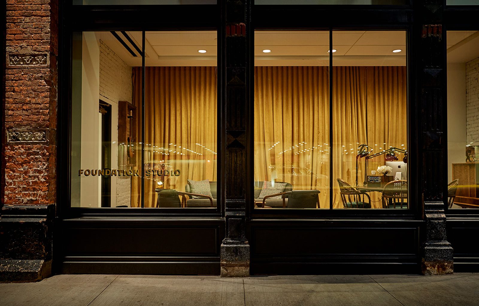 Round table and chairs through an exterior window of our Detroit boutique hotel