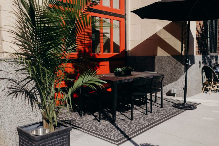 Outdoor dining table at our hotel in Detroit, in front of a red window