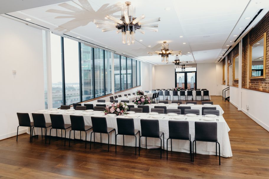 Banquet tables with floral centerpieces set up for a downtown Detroit event