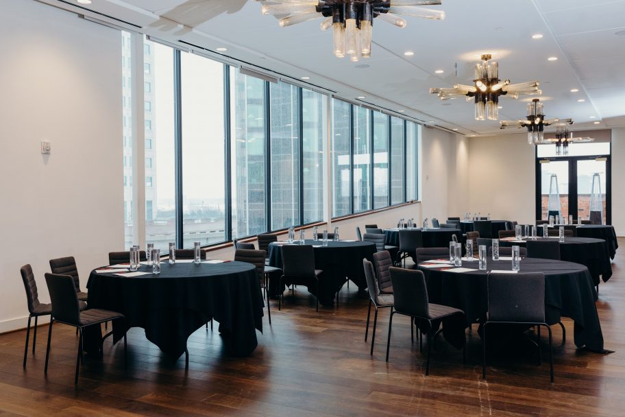 Tables set in our Detroit meeting venue, featuring views of the city.