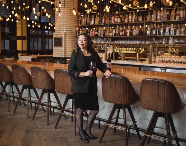 Classy woman posing by the bar of our downtown restaurant in Detroit