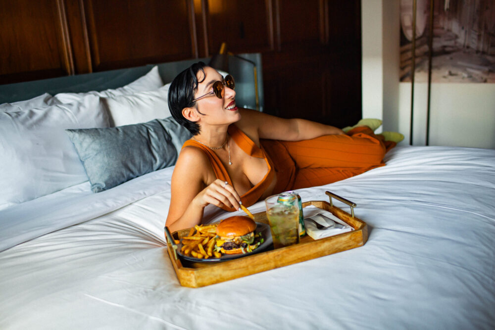 woman on bed eating food