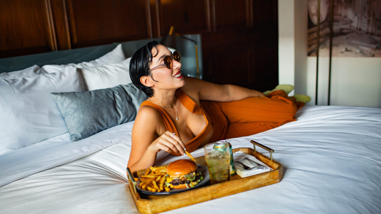 woman on bed eating food