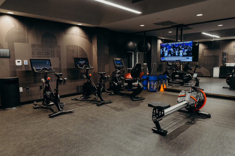 Several exercise bikes, a rowing machine, and a tv, at the hotel fitness center in downtown Detroit.