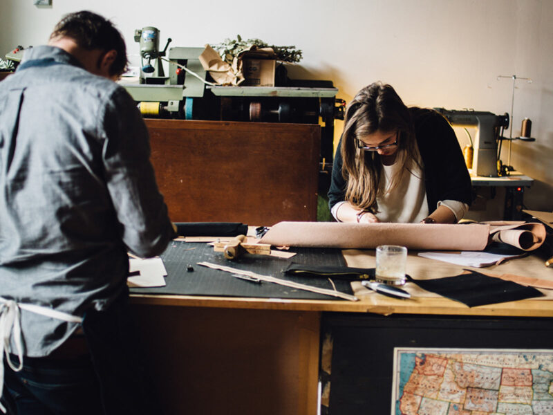 Woman cutting a strip of leather near our Detroit boutique hotel