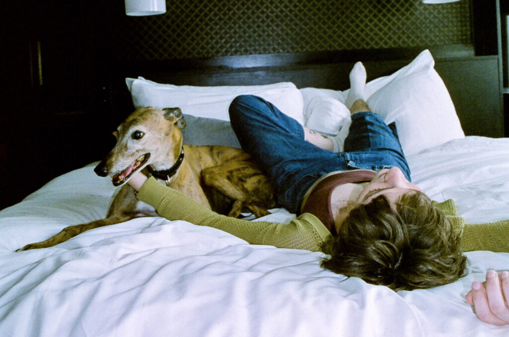 woman and dog on bed
