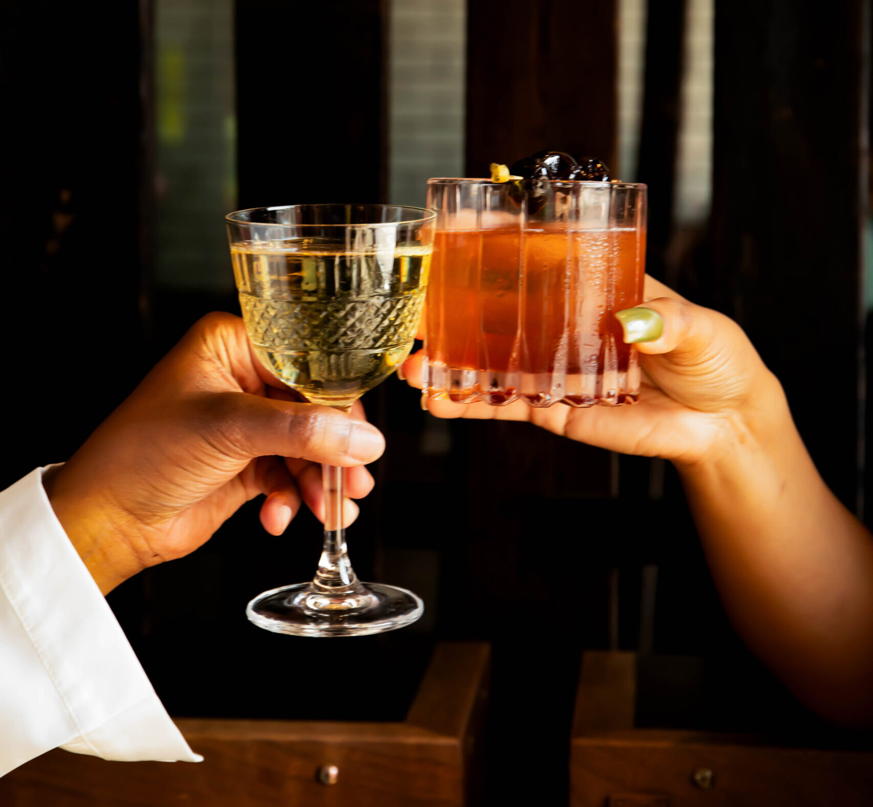 2 people cheersing a drink