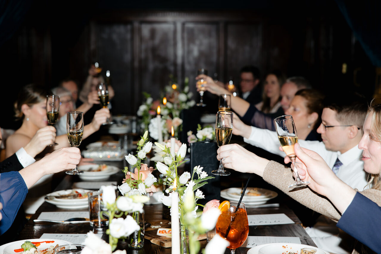 People celebrating a wedding all doing a toast