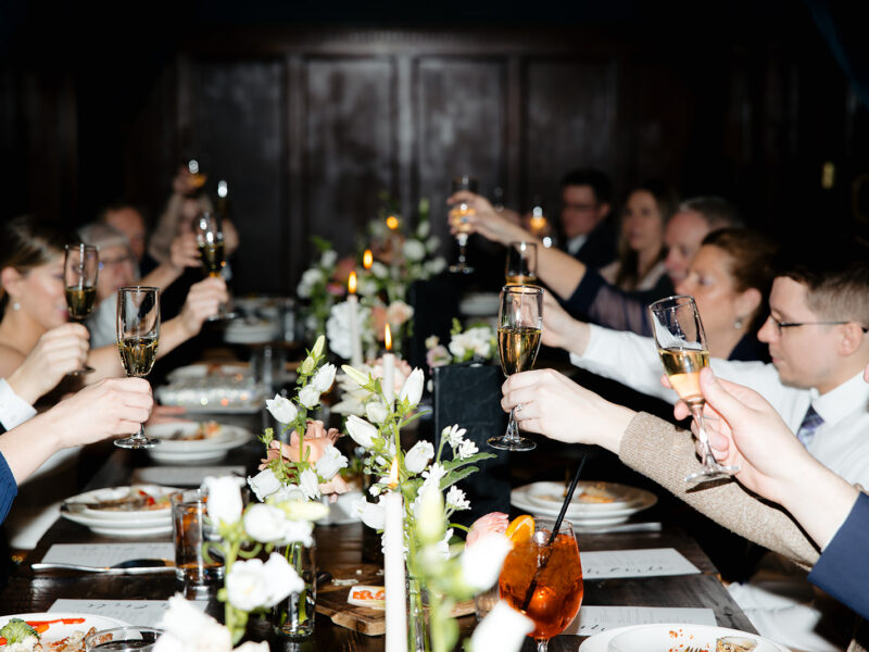 People celebrating a wedding all doing a toast