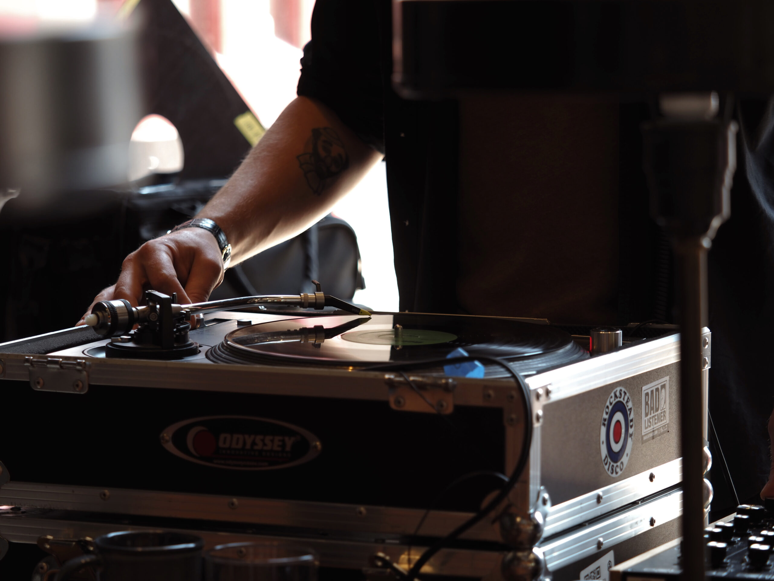 A DJ setting up a vinyl player
