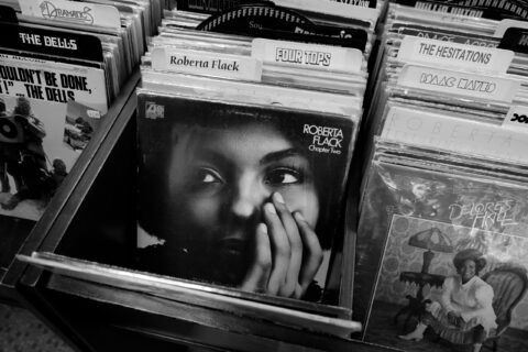 Close-up of vinyl records in bins; foreground shows Roberta Flack's Chapter Two cover with a woman's face.